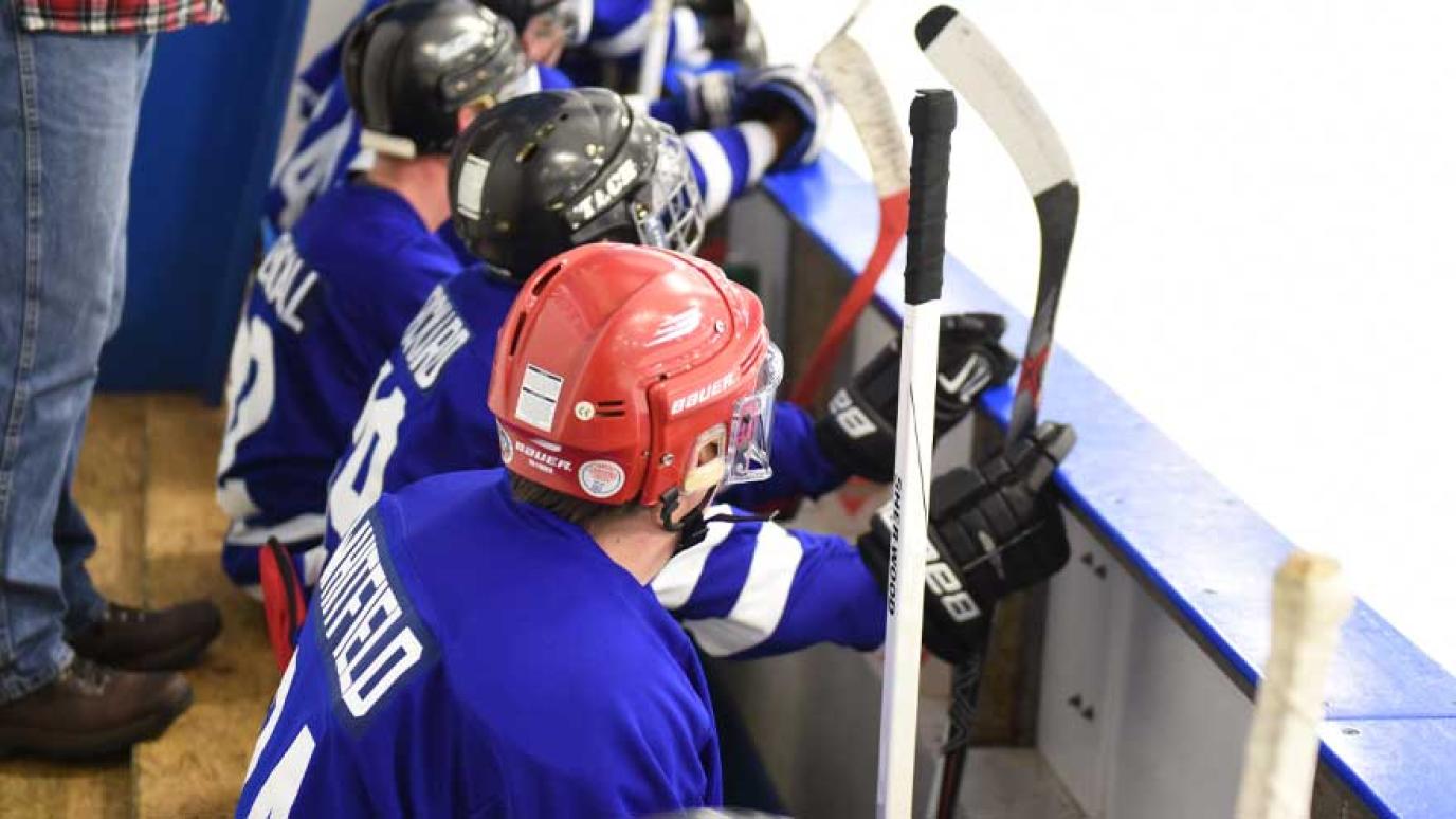 Wellington Dukes hockey players sitting on the bench