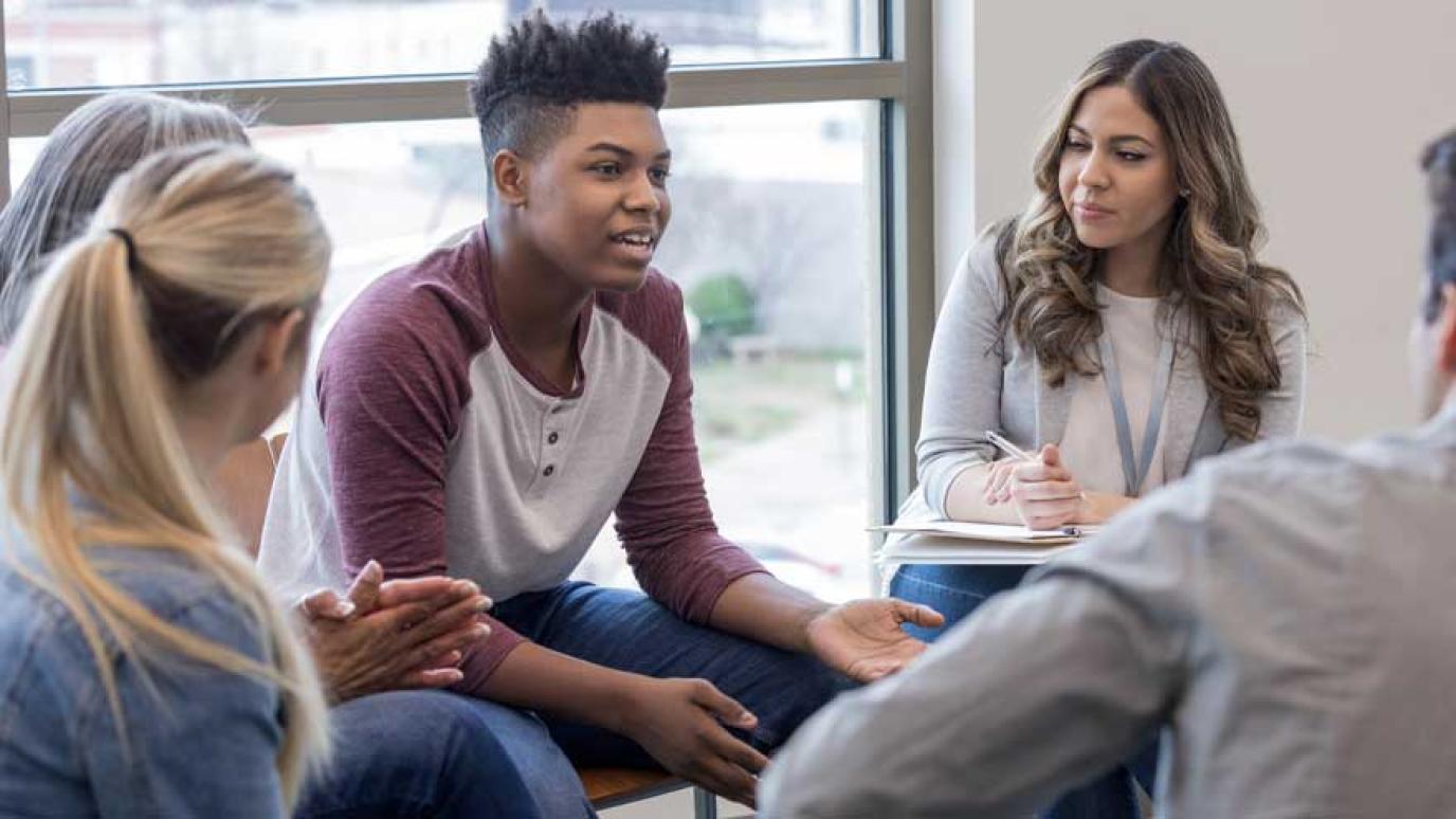 Group of youth having a discussion circle