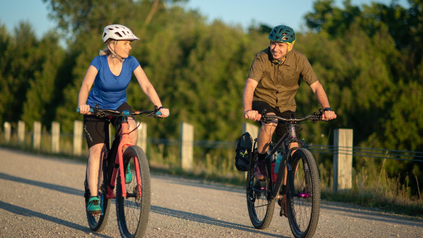 two people biking down road
