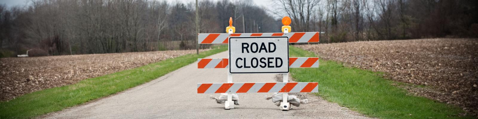 Road Closure sign blocking a rural road